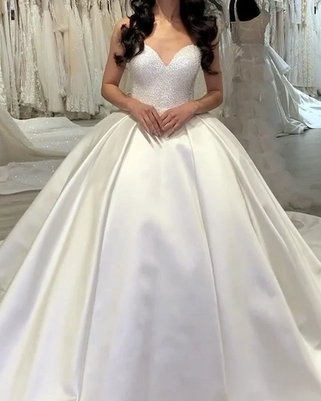 Wedding Dresses with Pleated Skirts and Lace Overlay and Bow at the Back for a Feminine and Timeless LookSweetheart Wedding Dress Pearl Beaded Satin Ball Gown Wedding Dresses with Pleated Skirts and Lace Overlay and Bow at the Back for a Feminine and Timeless LookSweetheart Wedding Dress Pearl Beaded Satin Ball Gown