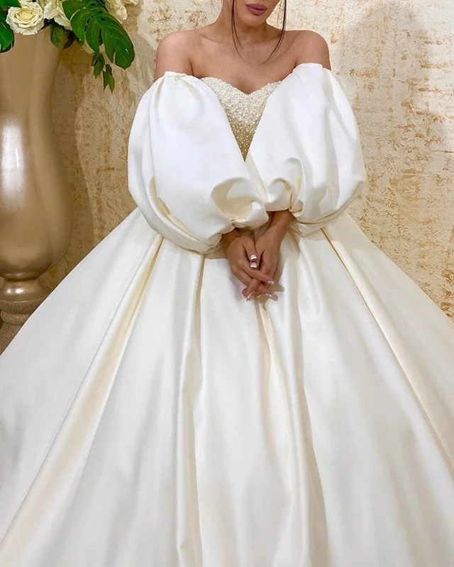 Wedding Dresses with Lace Insertions on the Skirt and Beaded Waistband and Ruffled Hem and Bow at the Waist for a Feminine and Flirty LookRemovable Sleeves Wedding Dress Ball Gown Sweetheart Pearl Beaded